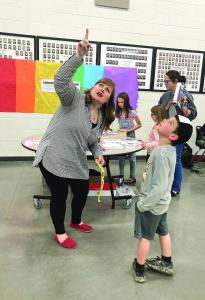 Lamar School District held an eclipse-themed STEAM (science, technology, engineering, art, and mathematics) night for students and families on April 4. Various teachers and organizations hosted booths in the high school cafeteria with learning activities and demonstrations to teach about the science behind the total solar eclipse. Judith Little, AP biology teacher at Lamar High School (left), explains to second grader Ruger Masterson how the filters in eclipse glasses protect your eyes from the sun’s bright rays and prevent blindness and permanent eye damage. The eclipse glasses must be worn for safety except for the brief period of totality. --Graphic photo by Stephanie Baker